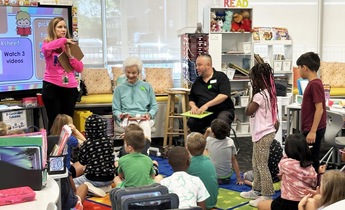 Civitas Senior Living | Senior woman reading a book to children