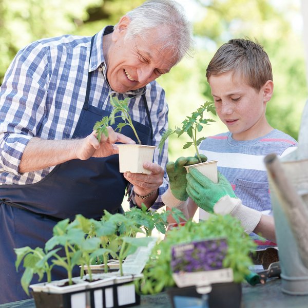 Legacy Oaks of Midlothian | Senior man gardening with grandson