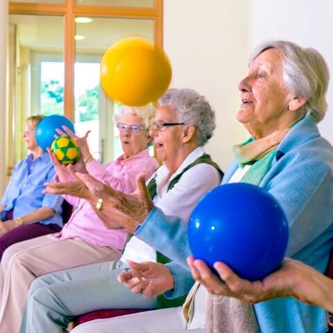 Legacy Oaks of Midlothian | Seniors doing chair exercises with bouncy balls