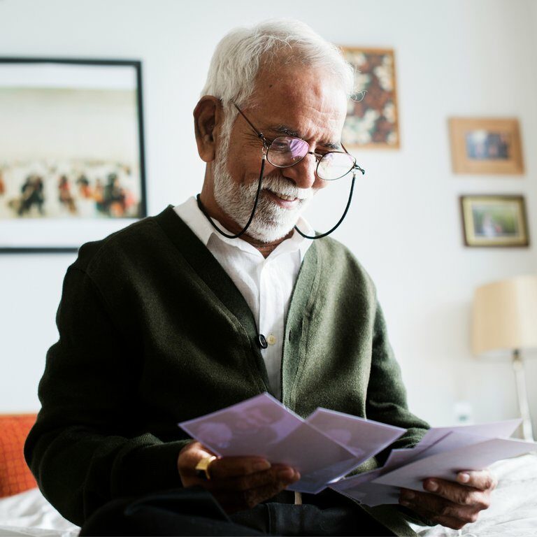 Long Creek | Senior man looking at photos