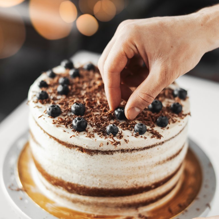 Stone Creek of Copperfield | Chef garnishing cake with blueberries