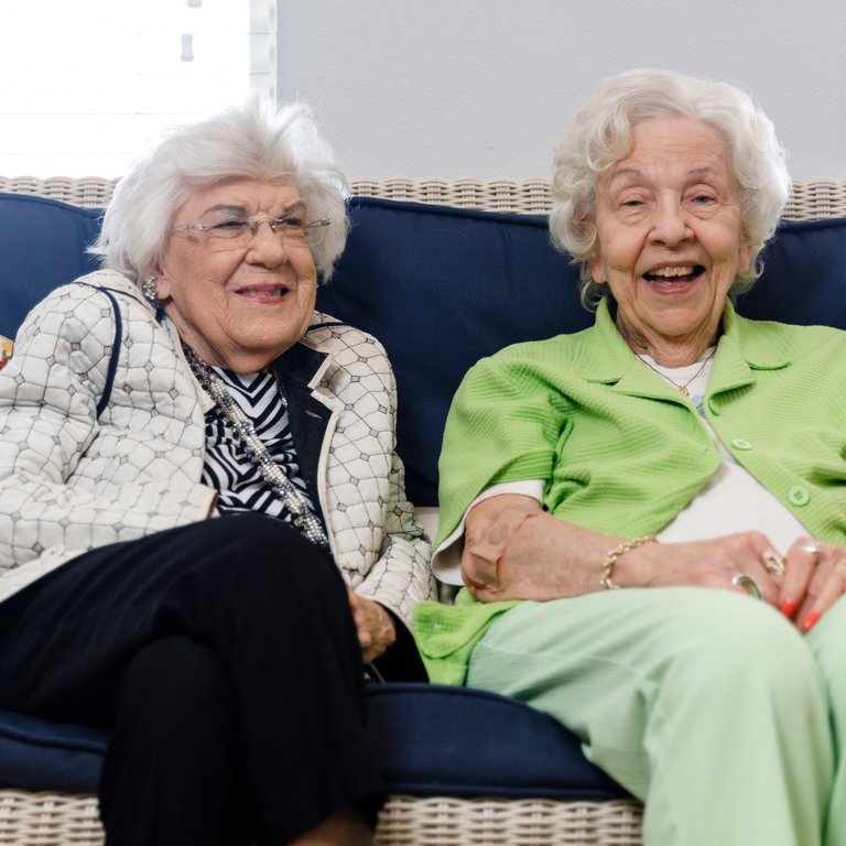 Stone Creek of Copperfield | Senior women smiling on couch