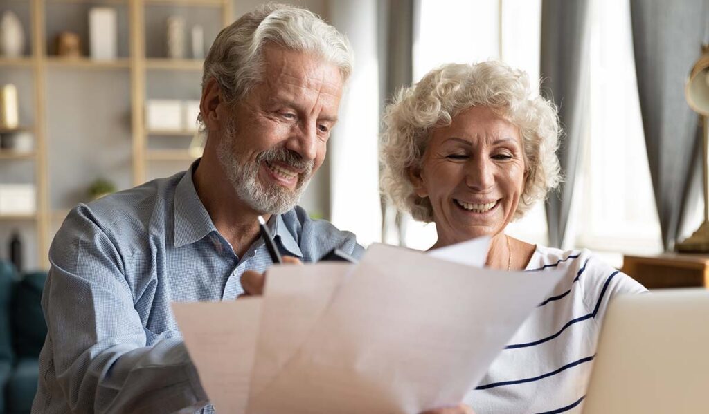 Civitas Senior Living | Senior couple use online banking on laptop planning family budget