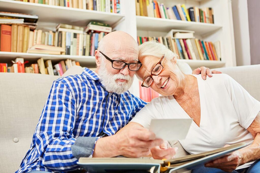StoneCreek of Copperfield | Happy senior couple smiling while looking at old photos