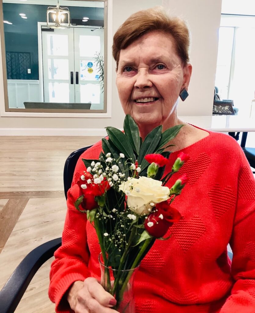 Stonecreek of Copperfield | Senior resident holding flowers