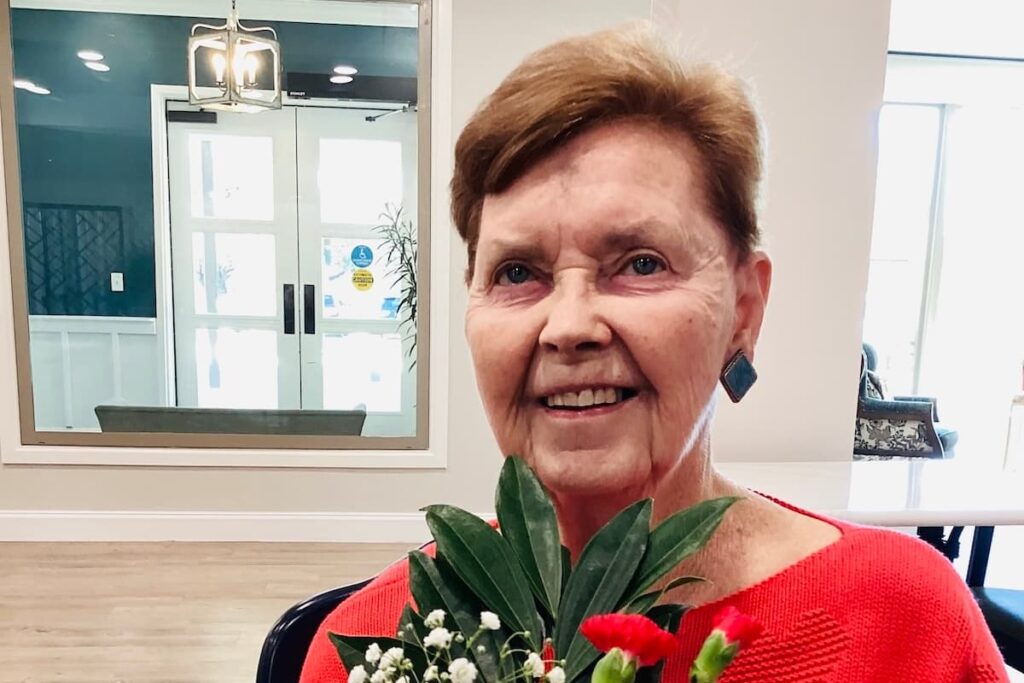 Stonecreek of Copperfield | Senior resident holding flowers