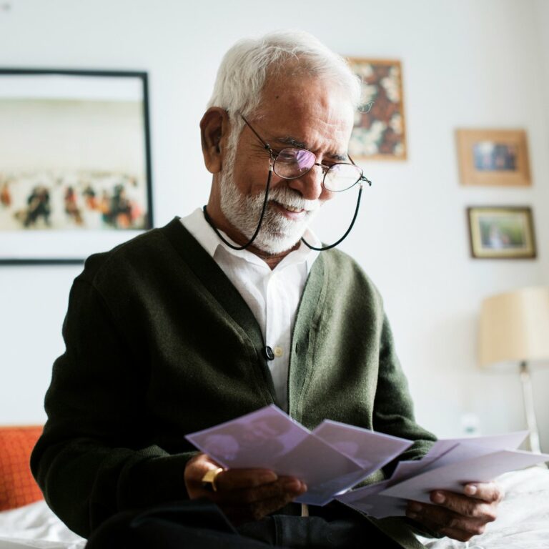 StoneCreek of Flying Horse | Senior man looking at photographs