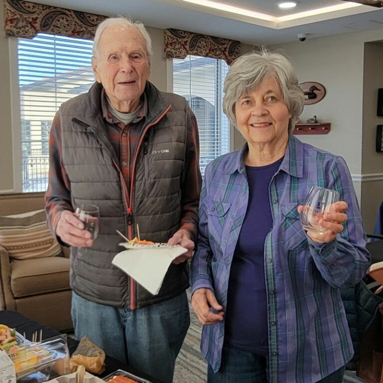 StoneCreek of Flying Horse | Senior couple getting food from catering table