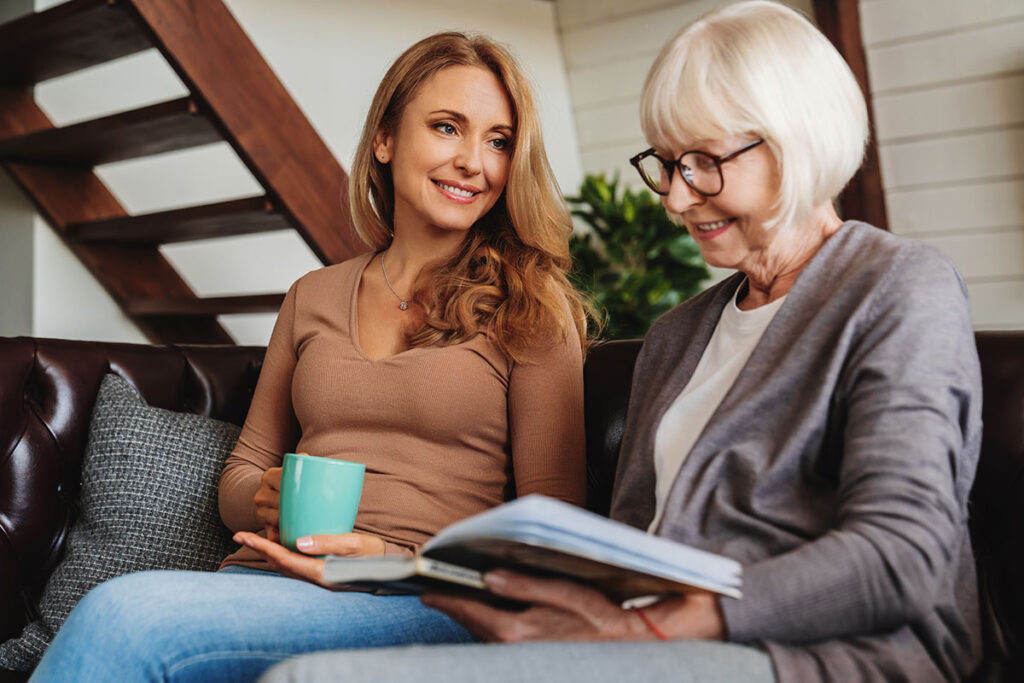 StoneCreek of Flying Horse | Senior mother reading a book with daughter