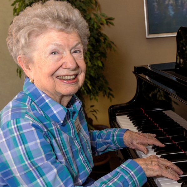 StoneCreek of Littleton | Senior woman playing piano
