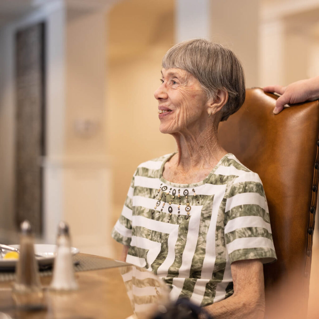 StoneCreek of North Richland Hills | Senior woman smiling at dining table