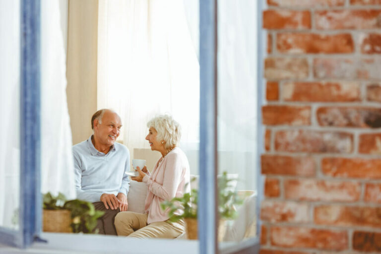 StoneCreek of North Richland Hills | Senior couple taking while sitting on the couch