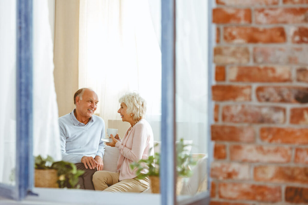 StoneCreek of North Richland Hills | Senior couple taking while sitting on the couch