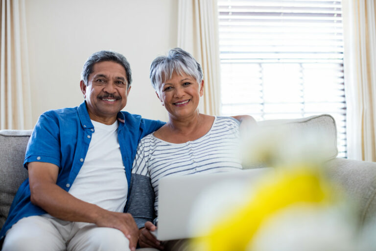 Civitas Senior Living | Senior couple using their computer on the sofa