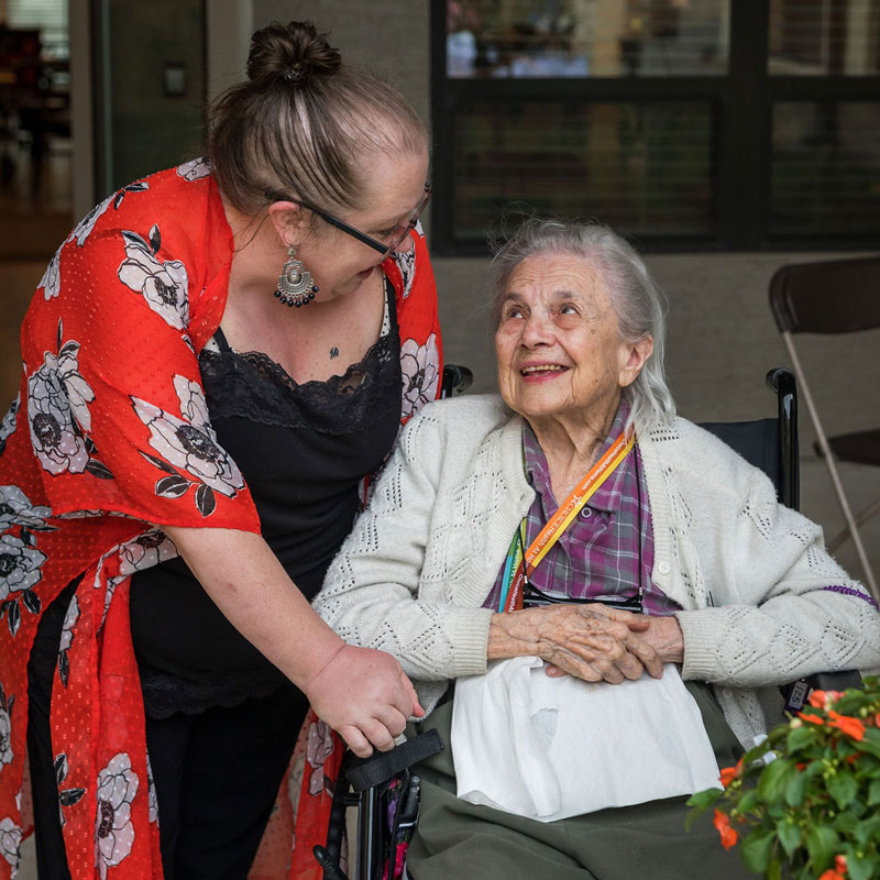 Tech Ridge Oaks | Senior and caregiver talking and smiling