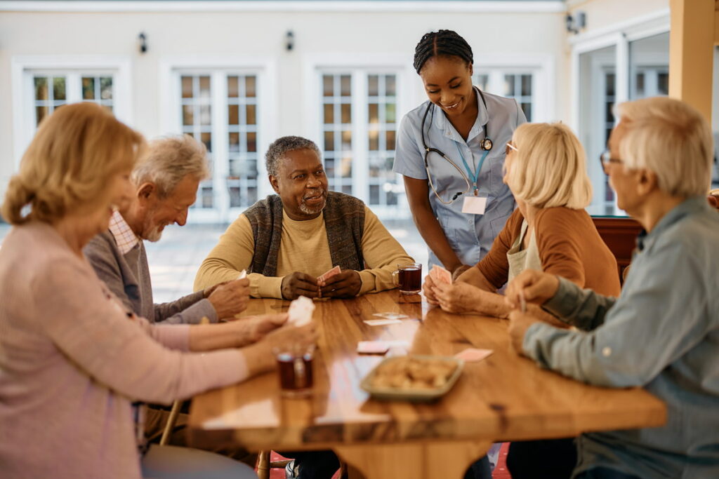 Tech Ridge Oaks | Group of seniors laughing and playing cards