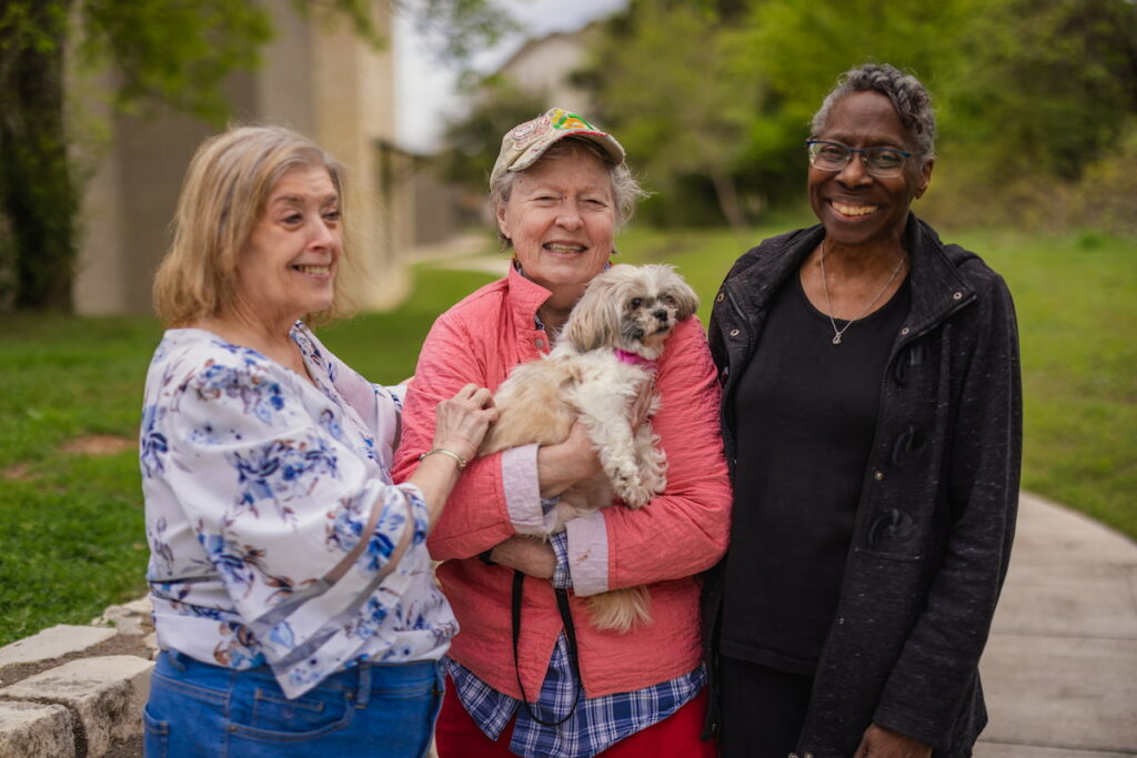 Tech Ridge Oaks | Seniors walking and playing with a dog