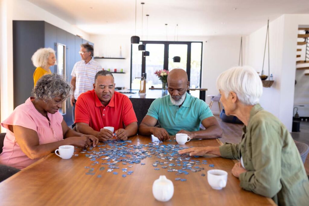 The Avenues of Fort Bend | Group of happy seniors doing a puzzle