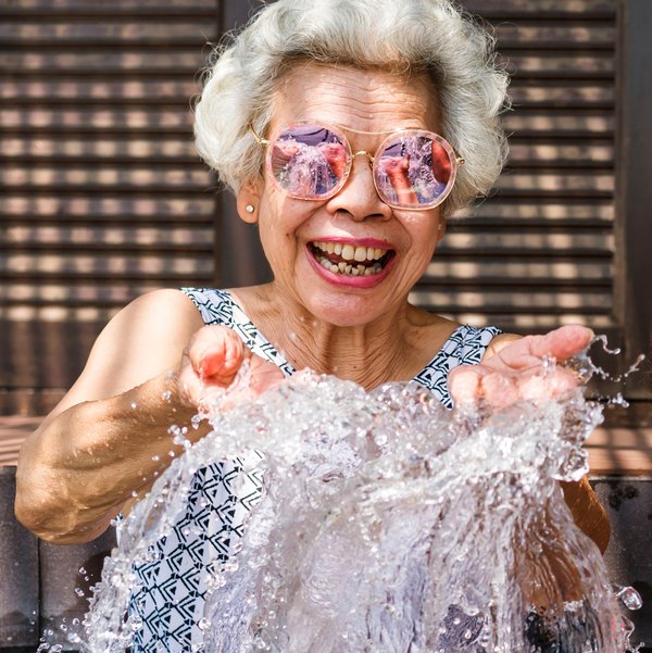 The Bluffs of Flagstaff | Happy senior woman splashing water