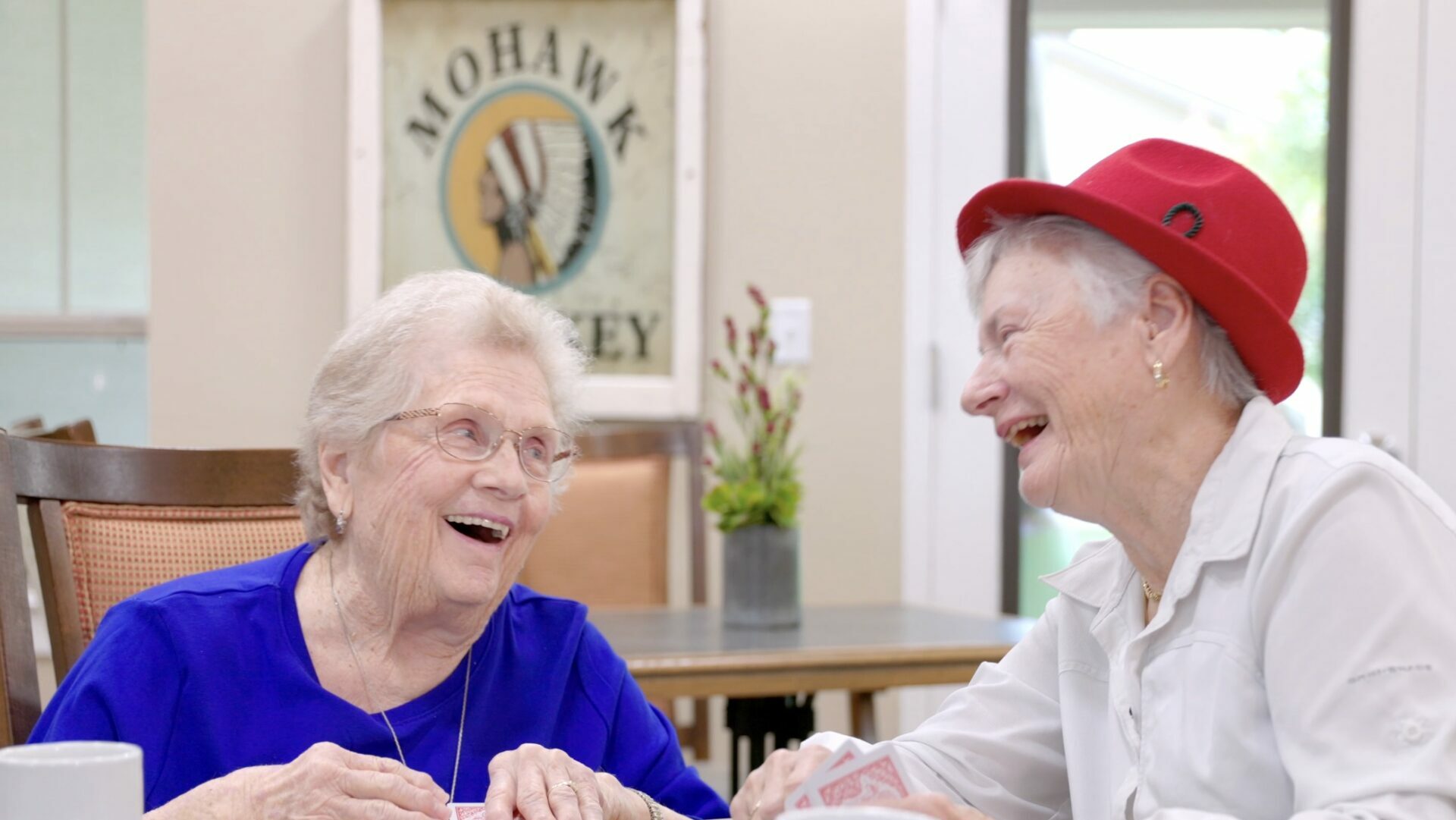 The Bluffs of Flagstaff | Two senior woman laughing while playing cards