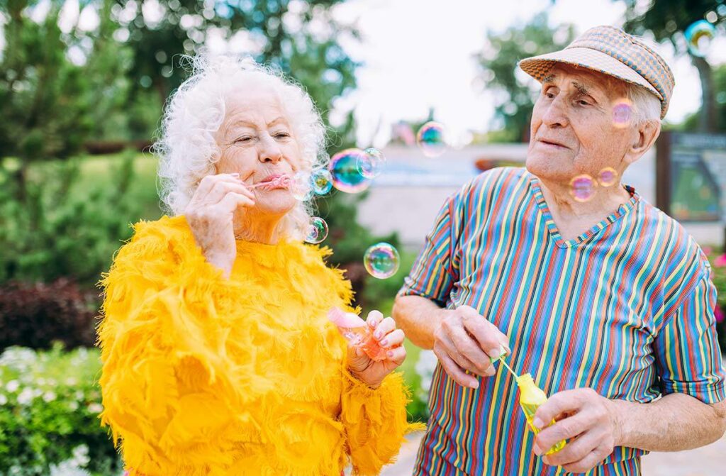 The Bluffs of Flagstaff | Senior man and woman blowing bubbles outside