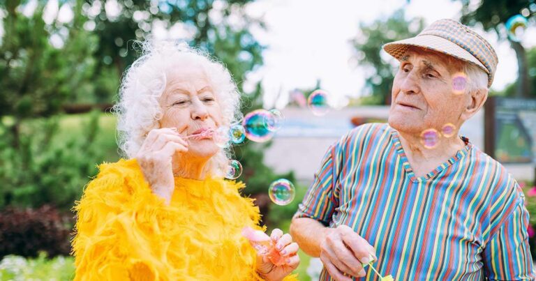 The Bluffs of Flagstaff | Senior man and woman blowing bubbles -social