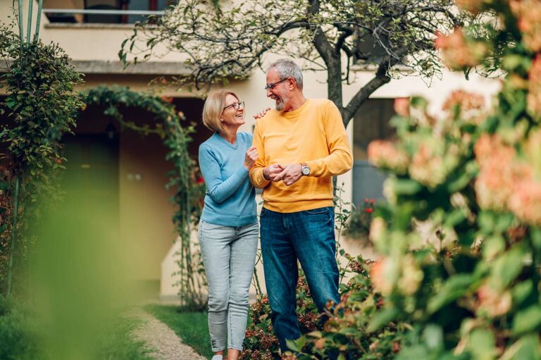 The Bluffs of Flagstaff | Senior couple walking through a garden