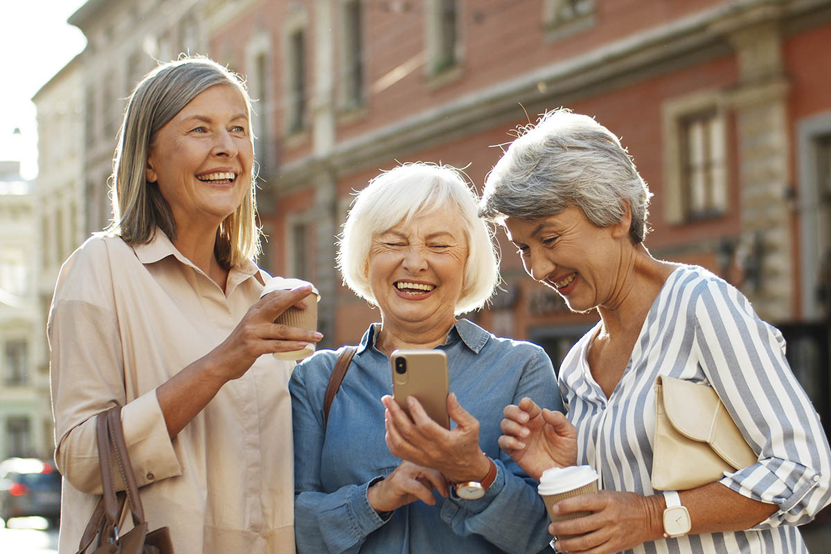 The Bluffs of Flagstaff | Three beautiful and cheerful Caucasian women with coffee to-go