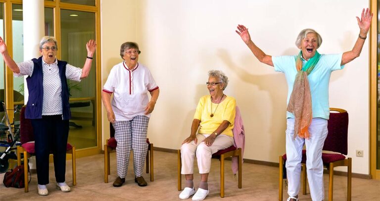 The Bluffs of Flagstaff | Flagstaff care homes | Senior women standing and sitting for exercise