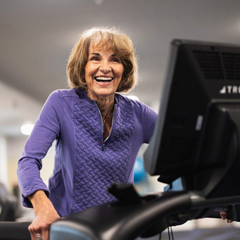 The Bluffs of Flagstaff | Senior woman on elliptical smiling