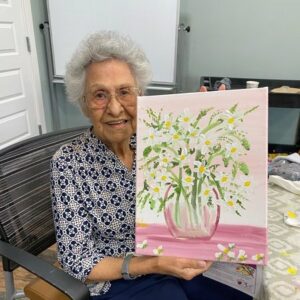 The Brooks of Cibolo | Delia holding up her painting