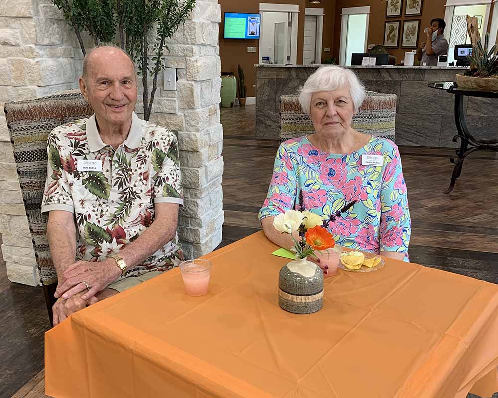 The Brooks of Cibolo | Seniors sitting at table and smiling