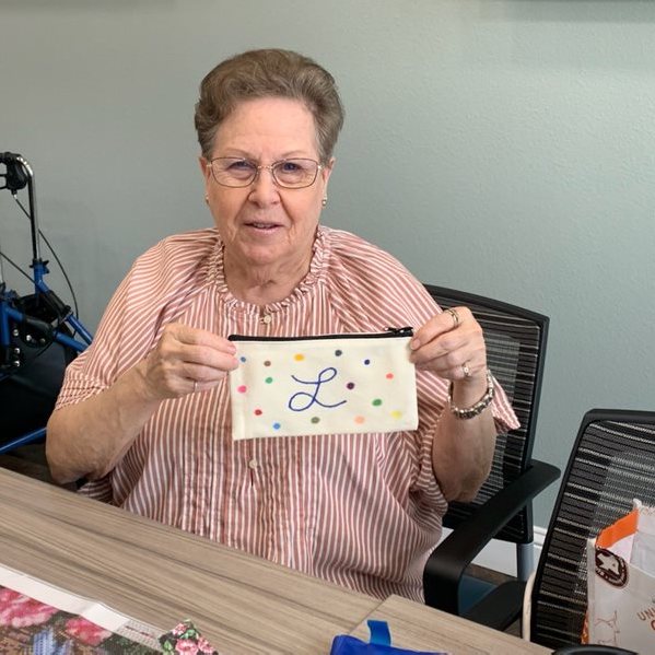The Brooks of Cibolo | Senior woman showing her arts and crafts project