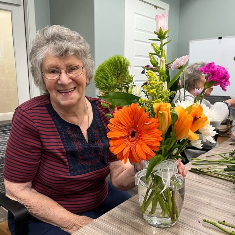 The Brooks of Cibolo | Senior woman with bouquet of flowers on national floral design day