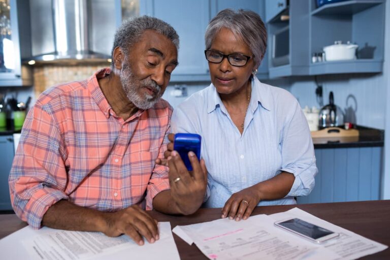 Civitas Senior Living | Senior man and woman at table looking at monthly expenses