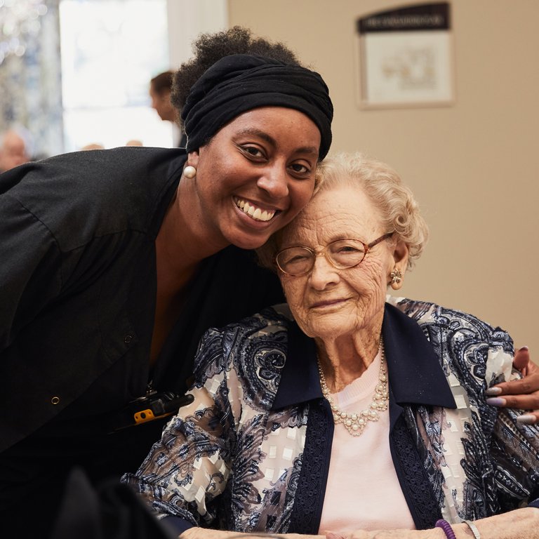 The Gallery at North Port | Associate hugging resident