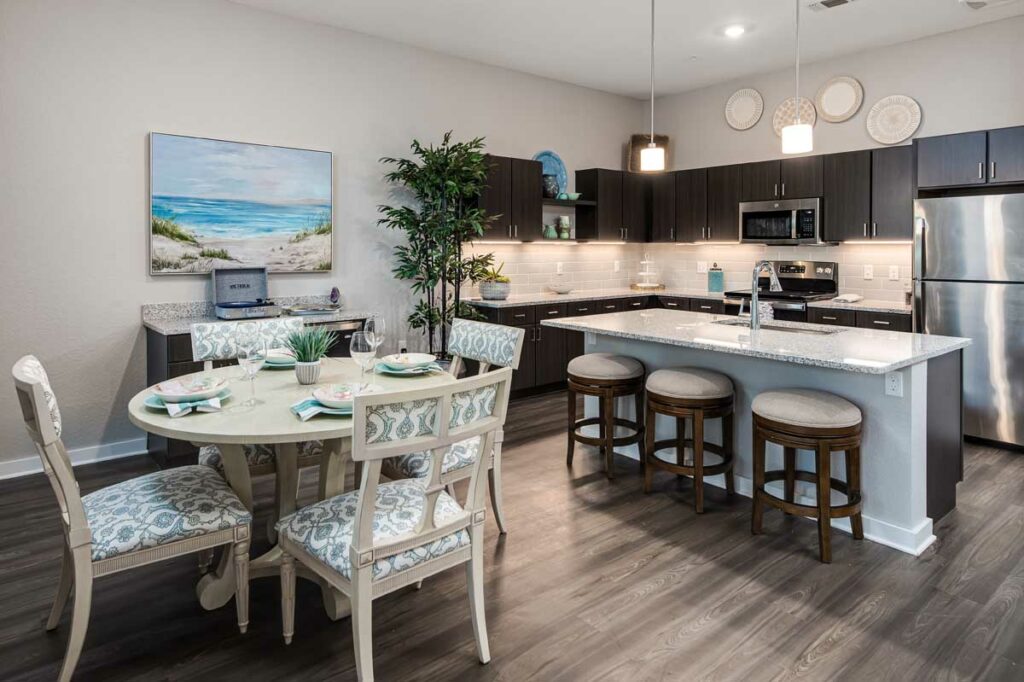 The Gallery at North Port | Kitchen, island with bar, and dining table