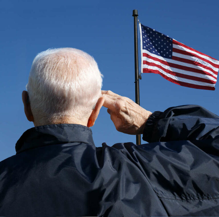 The Gallery at Port Orange | Senior veteran saluting the American flag