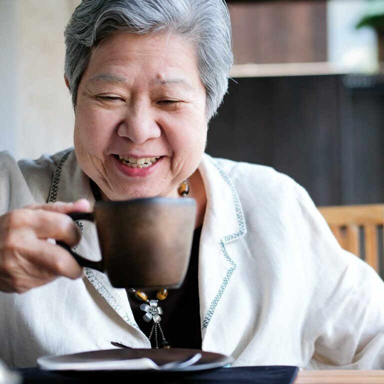The Grand | Senior woman drinking coffee