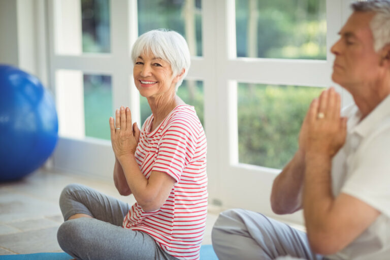 The Grand | Senior woman meditating and smiling