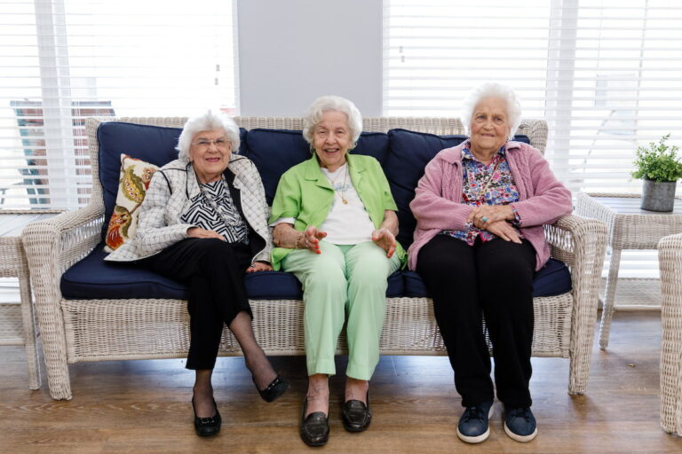 Civitas Senior Living | Senior women sitting and laughing on the sofa