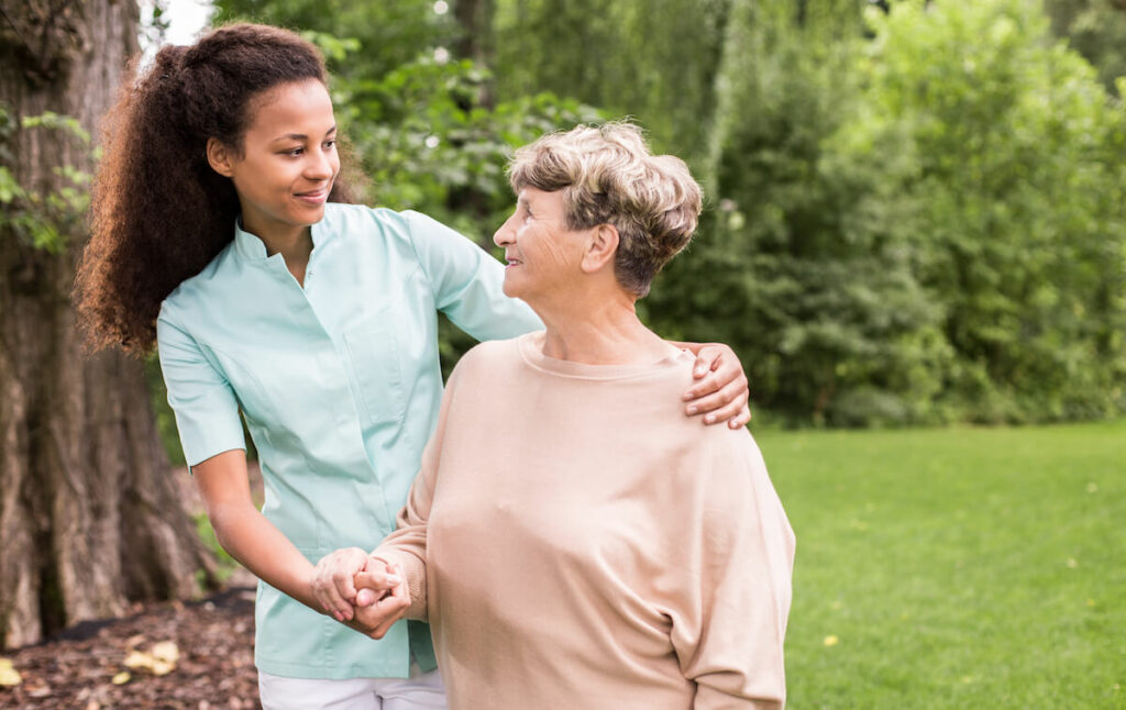 The Grandview of Chisholm Trail | Senior woman and her caregiver standing outside