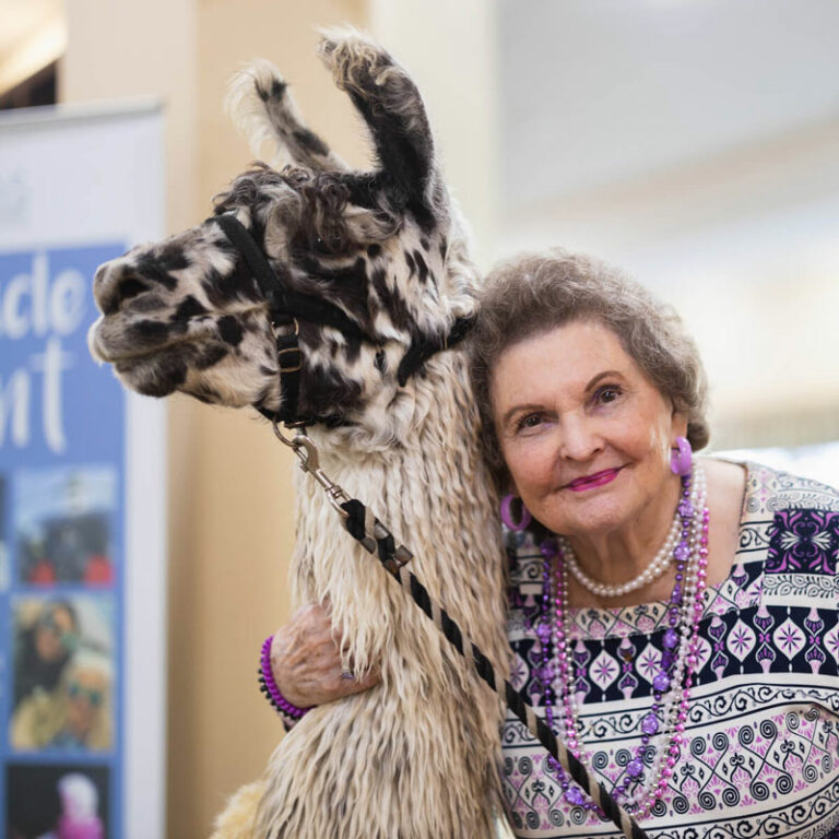 The Grandview of Chisholm Trail | Senior woman next to llama