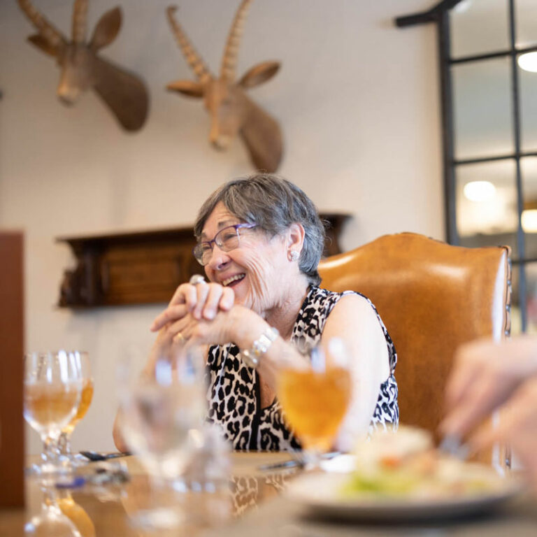 The Grandview of Chisholm Trail | Senior woman smiling at table