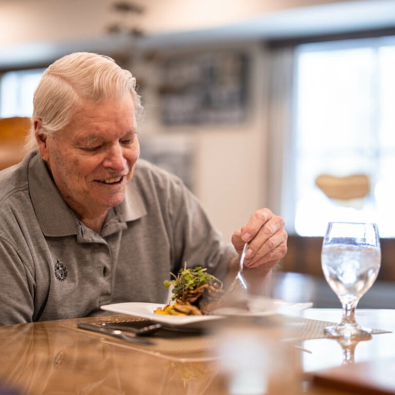 The Grandview of Chisholm Trail | Senior man enjoying meal in dining hall