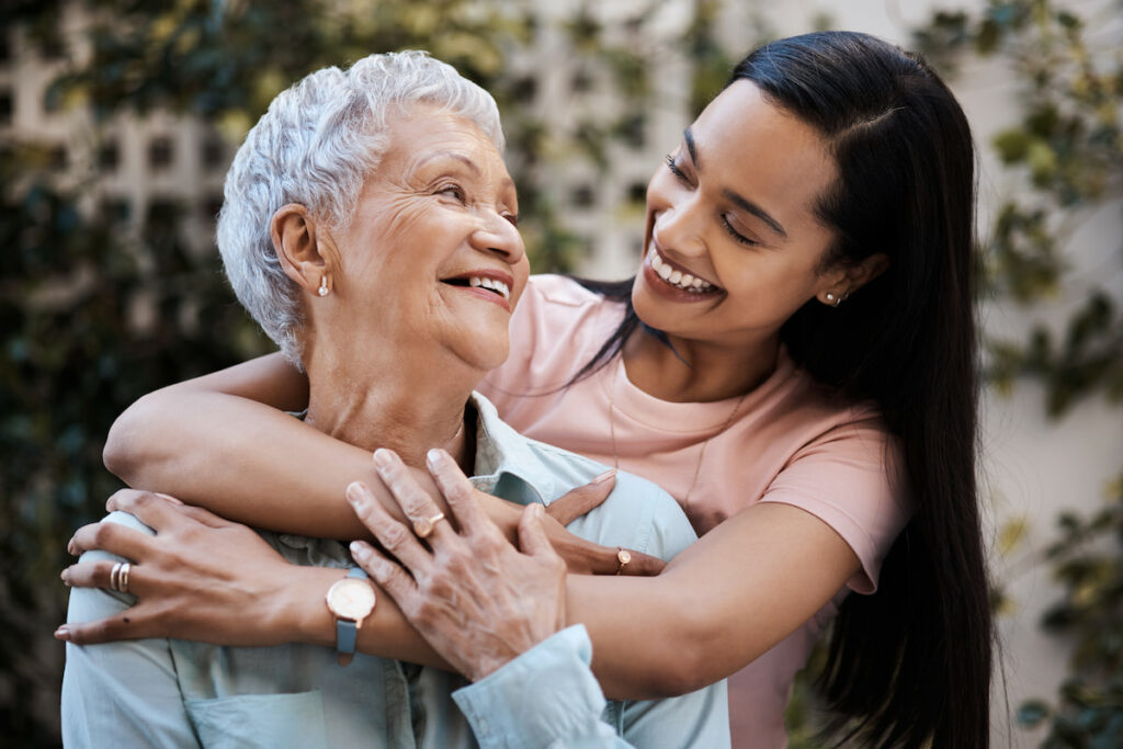 The Grandview of Chisholm Trail | Daughter huggin mother from behind and smiling