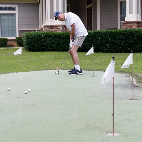 The Hamptons | Senior playing in putting green