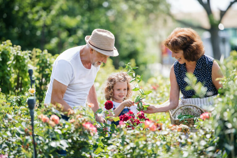 The Hamptons | Senior man and his granddaughter admiring the rose garden