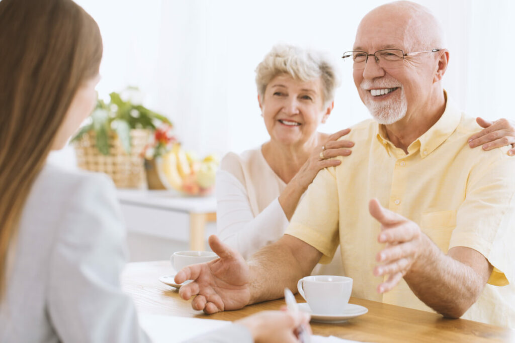 Civitas Senior Living | Happy senior couple talking to a professional about senior living
