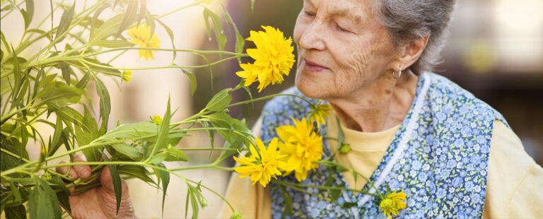 Civitas Senior Living | Senior woman smelling flowers